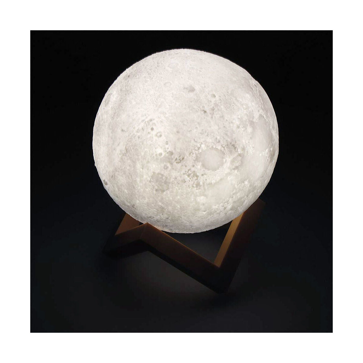 Moon-shaped lamp on a stand with a black background